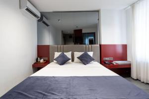 a bedroom with a large white bed with blue pillows at Abone Suites in Istanbul