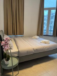 a bedroom with a bed with a table and a window at Apartment Close to Zuid Park in Antwerp