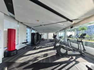 a gym with treadmills and ellipticals in a building at Comfortable Zone in Klong Toi