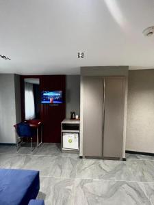 a room with a bed and a tv on the wall at Abone Suites in Istanbul