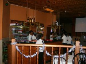 a group of people standing at a bar at Crystal Hotel in Asmara