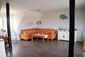 a living room with a couch and a table at Gänseblümchen in Fehmarn