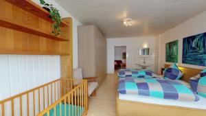 a bedroom with two beds and a staircase at Strandhöhle in Borkum
