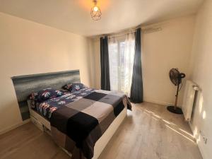 ジュヴィジー・シュロルジュにあるDucastel F2 Apptのベッドルーム1室(ベッド1台、ファン付きの窓付)