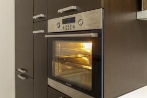 an oven with its door open in a kitchen at Appartamento Palazzo dei Duchi 1 in Avigliana