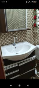a white sink in a bathroom with a mirror at Casa Soul de Verão in Ilha Comprida +15 photos