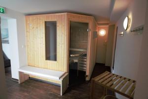 a room with a wooden cabinet and a bench at Jantje in der Villa Patricia in Borkum +11 photos