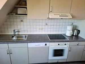 a kitchen with a sink and a counter top at Kleeblatt in Fehmarn