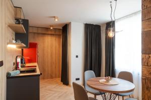 a kitchen and dining room with a table and chairs at Уютно Студио Verde Suites 07 in Blagoevgrad +5 photos
