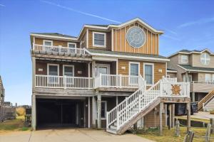 a large house with a garage in front of it at Dream Catcher in Nags Head