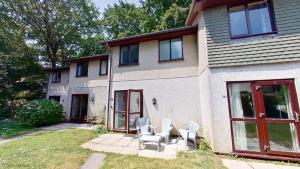 a house with two white chairs sitting outside of it at Three bed Holiday Home in Hayle