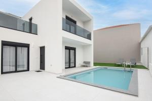 an exterior view of a house with a swimming pool at Tolis Exclusive Villa in Kissamos