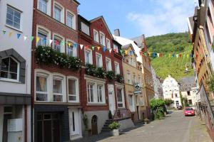 a street in a town with flags and buildings at Haus Budinger in Alf +4 photos