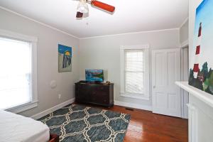 a bedroom with a bed and a ceiling fan at Hill House - Pet friendly, In town with water views! in Chincoteague