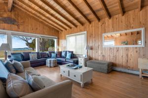 a living room with a couch and a table at Huntington Farm - Pristine Historical Home Overlooking Cherrystone Creek! in Cape Charles