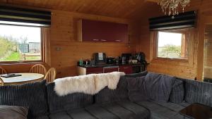 a living room with a couch and a kitchen at Graystock Lodge in Lancaster