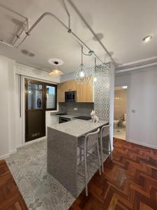 a kitchen with a island in the middle of a room at Plaza España Vigo in Vigo