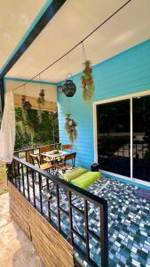 a balcony with a table and chairs on a house at Tiny Boutique House Koh Kood in Ban Lak Uan