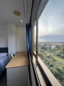 a room with a window with a bed and a view at Plaza España Vigo in Vigo