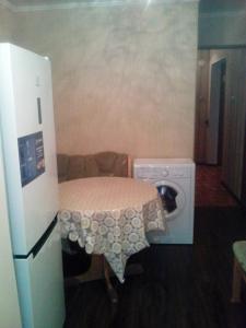 ジェレスノヴォツクにあるApartment On Proskurina 41の小さなお部屋で、テーブル、洗濯機が備わります。