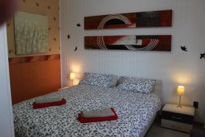 a bedroom with a bed with two red pillows at Casa HELI 1 in San Zeno di Montagna