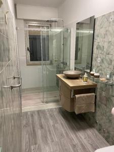 a bathroom with a sink and a glass shower at Casa HELI 1 in San Zeno di Montagna +22 photos