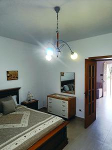 a bedroom with a bed and a dresser and a mirror at Villa Maria in Foce Varano