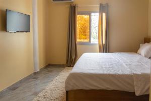 Ένα ή περισσότερα κρεβάτια σε δωμάτιο στο High-end 2BR apartment in the heart of Yaoundé