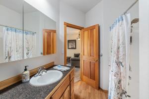 a bathroom with a sink and a mirror at THE INN Bigfork Bay in Bigfork +97 photos