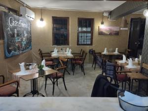 a restaurant with tables and chairs in a room at grand friends in Antalya