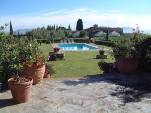 a garden with a swimming pool and some plants at Agriturismo Villani Poderi Nesti & Cupoli in Lastra a Signa