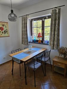 a dining room with a table and chairs and a window at Apartment Barbora 2 in Ružomberok