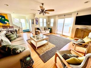 a living room with a couch and a table at La Vie - Waterfront, boat dock & Pool! in Chincoteague