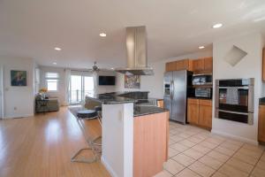 a kitchen with wooden cabinets and a counter top at La Vie - Waterfront, boat dock & Pool! in Chincoteague