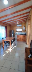 a large room with a wooden table and a kitchen at Cabaña irenio in Panguipulli +6 photos