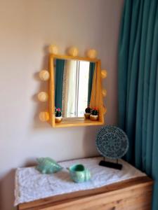 a mirror sitting on top of a dresser in a room at Egem House in Datca