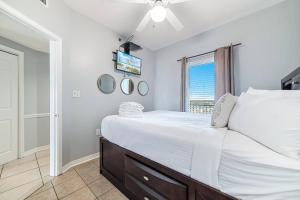 a bedroom with a large bed and a tv at Tidewater 807 in Orange Beach