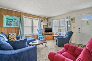 a living room with blue couches and a tv at Lazy Days - Pet friendly with screened gazebo! in Deep Hole