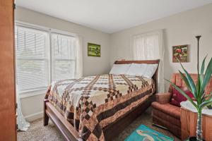 a bedroom with a bed and a chair and a window at Lazy Days - Pet friendly with screened gazebo! in Deep Hole