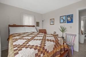 a bedroom with a bed with a quilt on it at Lazy Days - Pet friendly with screened gazebo! in Deep Hole