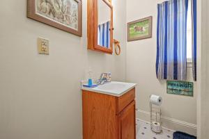 a bathroom with a sink and a mirror at Lazy Days - Pet friendly with screened gazebo! in Deep Hole