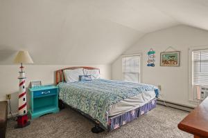 a bedroom with a bed with a blue end table at Lazy Days - Pet friendly with screened gazebo! in Deep Hole