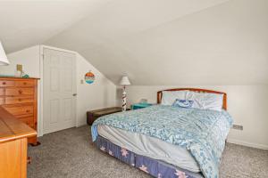 a small bedroom with a bed and a dresser at Lazy Days - Pet friendly with screened gazebo! in Deep Hole