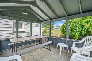 a screened porch with a bench and a table and chairs at Lazy Days - Pet friendly with screened gazebo! in Deep Hole