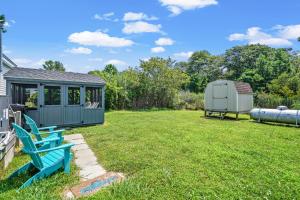 a yard with a gazebo and a blue bench at Lazy Days - Pet friendly with screened gazebo! in Deep Hole