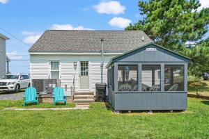 a gazebo with two chairs in a yard at Lazy Days - Pet friendly with screened gazebo! in Deep Hole