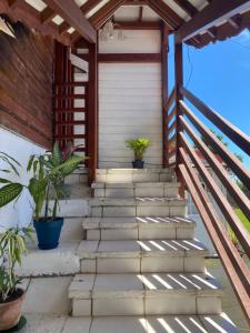 a set of stairs leading to a house with potted plants at Tite halte in Saint-Claude