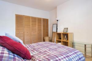 a bedroom with a bed with red pillows at Aberdeen City Flat, close to city centre in Aberdeen