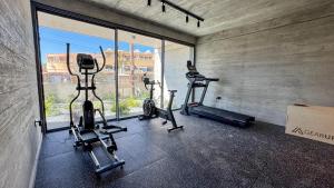 a gym with two tread machines and a window at Malberry Park 202 - Modern 2bedroom Apt with Shared Heated Pool, Sauna, Gym, Jacuzzi in Paphos City