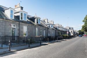 a row of houses on the side of a street at Aberdeen City Flat, close to city centre in Aberdeen